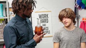 Security guard Devin Trez suspects young perp Troy Harlow of trying to steal, so he brings him to the backroom for further questioning. When Troy is left alone, he pulls out an expensive bottle of booze from under his pants...