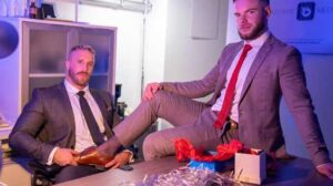 With just a few days before the employee Christmas party, CEO Mateo Tomas and assistant Marcus McNeill are setting up decorations around the office after hours.