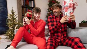 College student Jake Preston brought his boyfriend, Dom King, home for the holidays, but they have to sneak around! Jake unbuttons Dom's long underwear while Dom plays video games on
